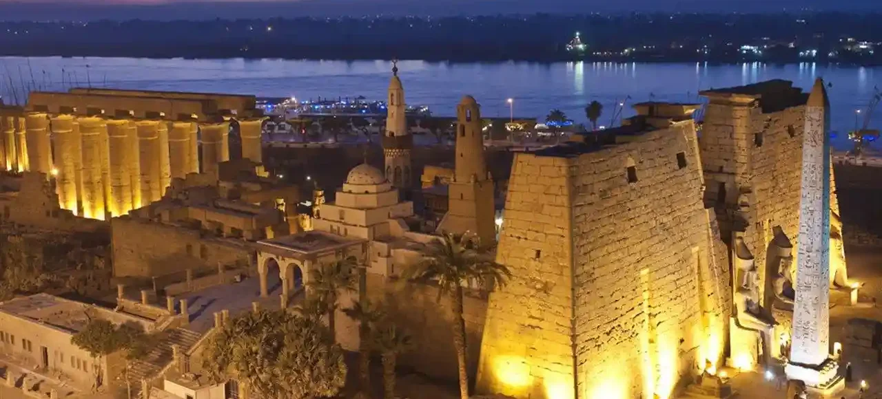 Luxor Temple illuminated at dusk during a Christmas holiday in Egypt